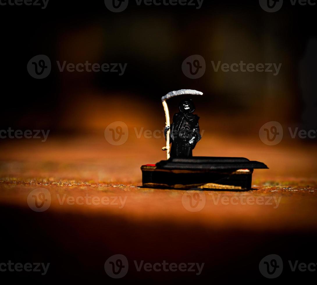 grim reaper in front of a coffin photo