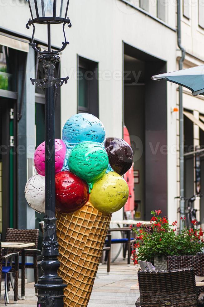 Colorful model of an ice cream cone outside a shop photo