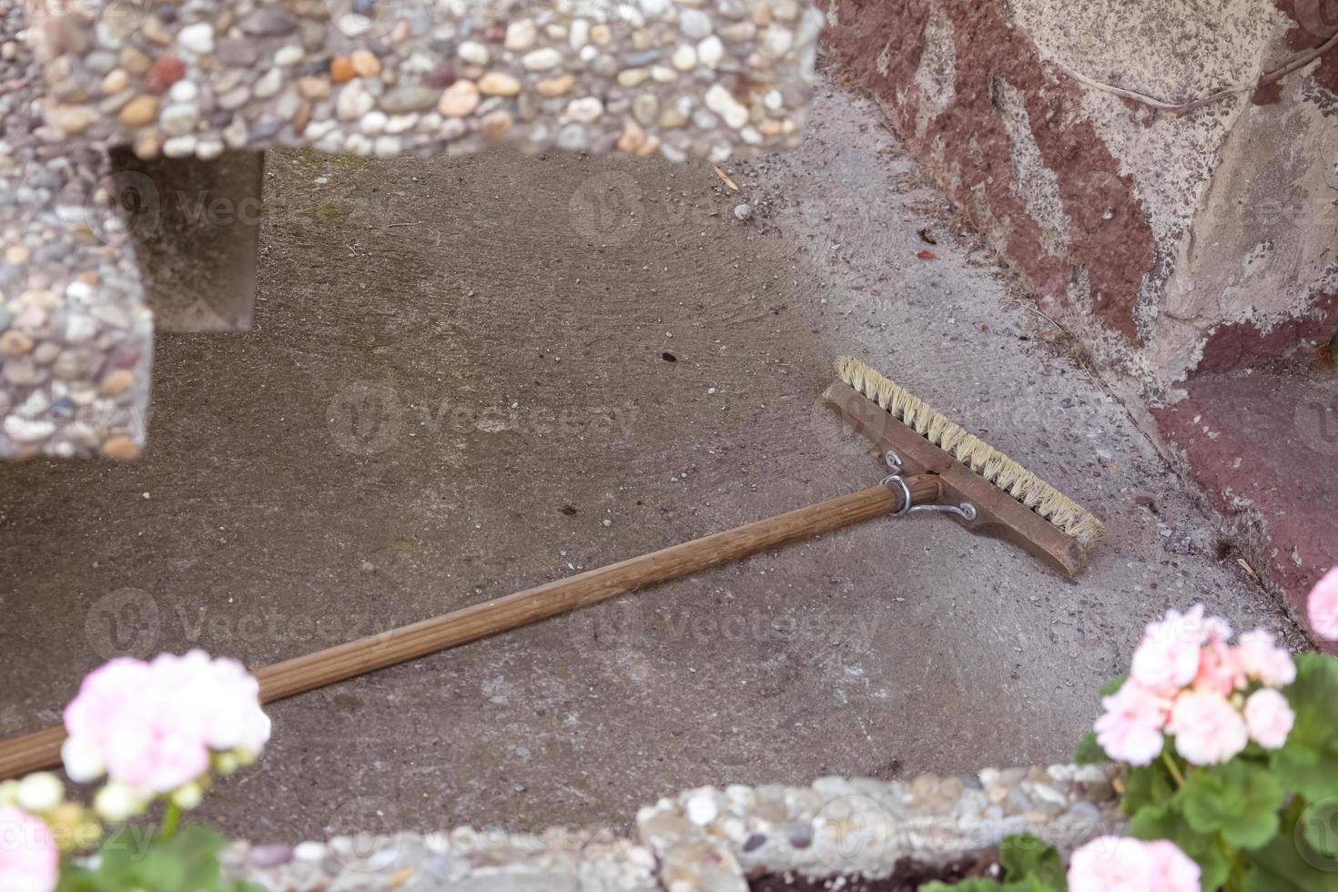 broom in front of an old house wall photo