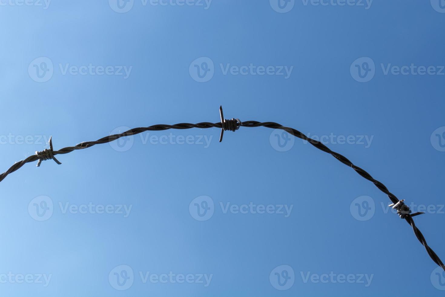 Barbed wire with blue sky photo