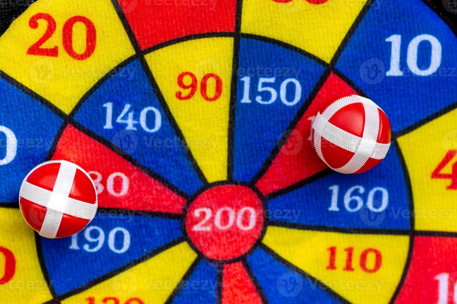 Two red balls placed on a colorful kids target photo