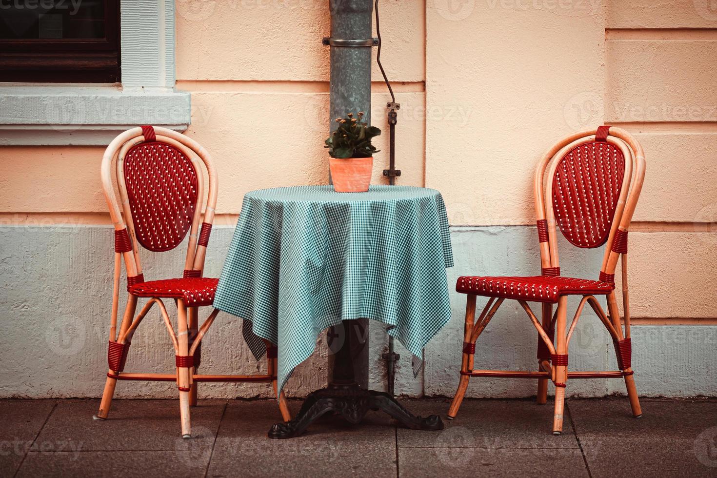Two classic style chairs and table outdoors photo