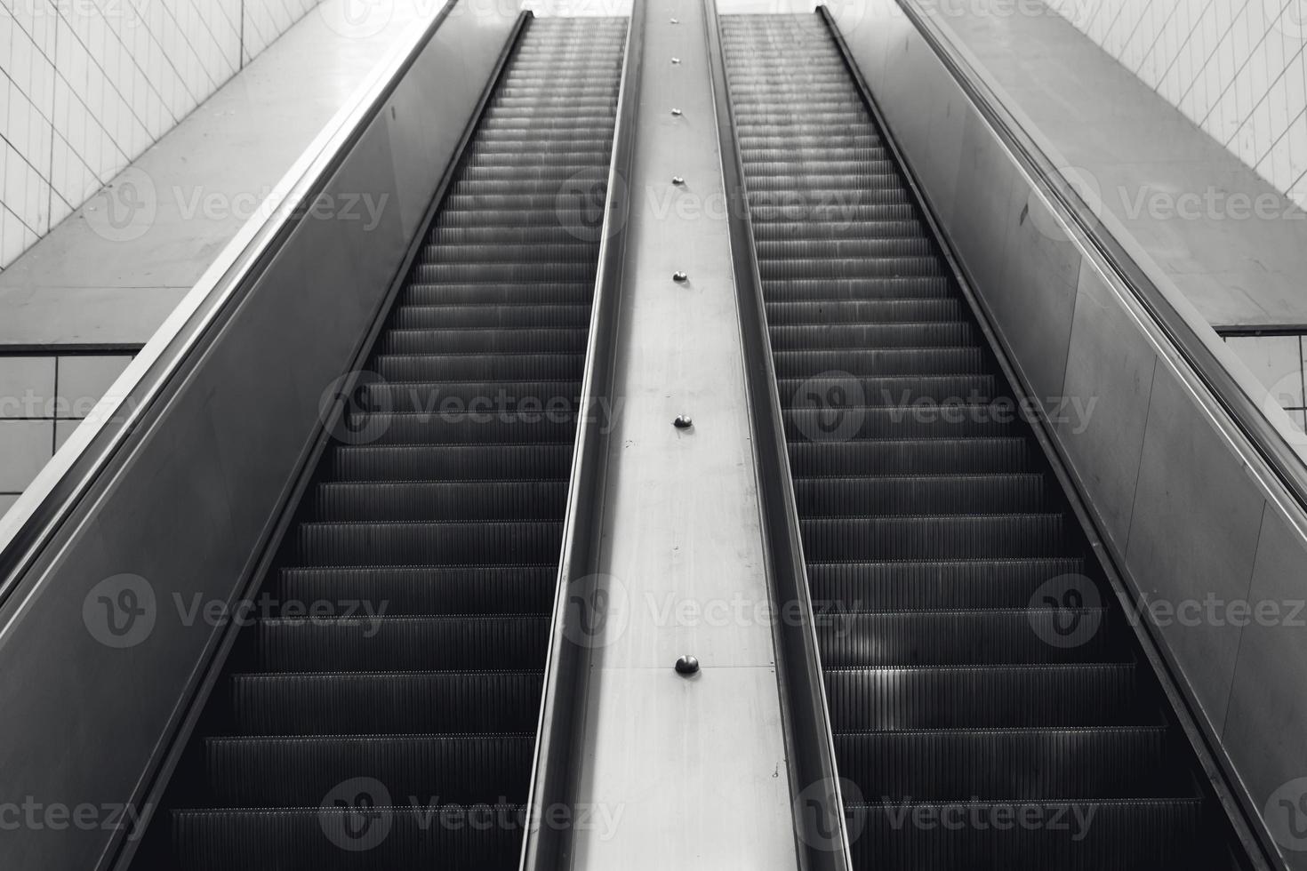 escalator in black and white shot photo