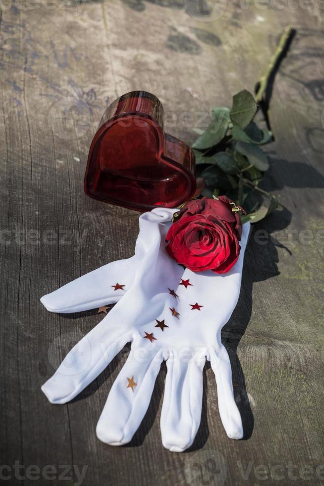 Valentines concept with red rose , heart and glove photo