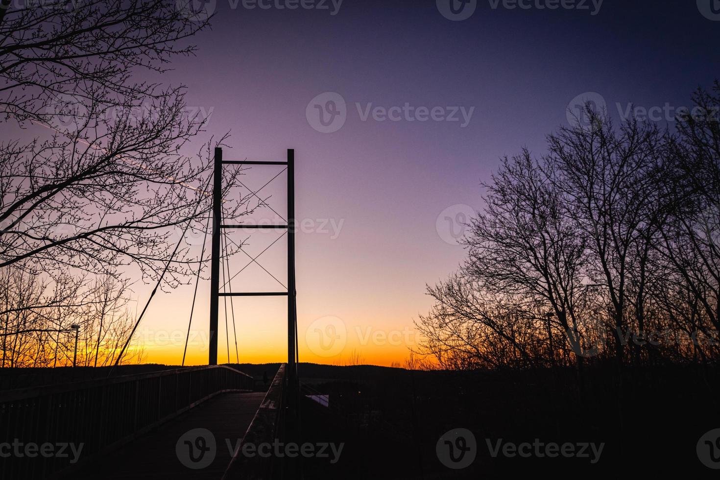 Low angle view of a silhouetted bridge at sunset photo