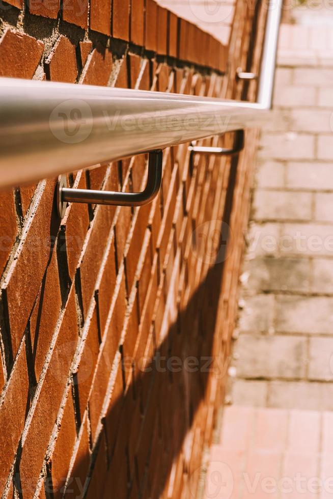 stair railing on a brick wall in close-up photo