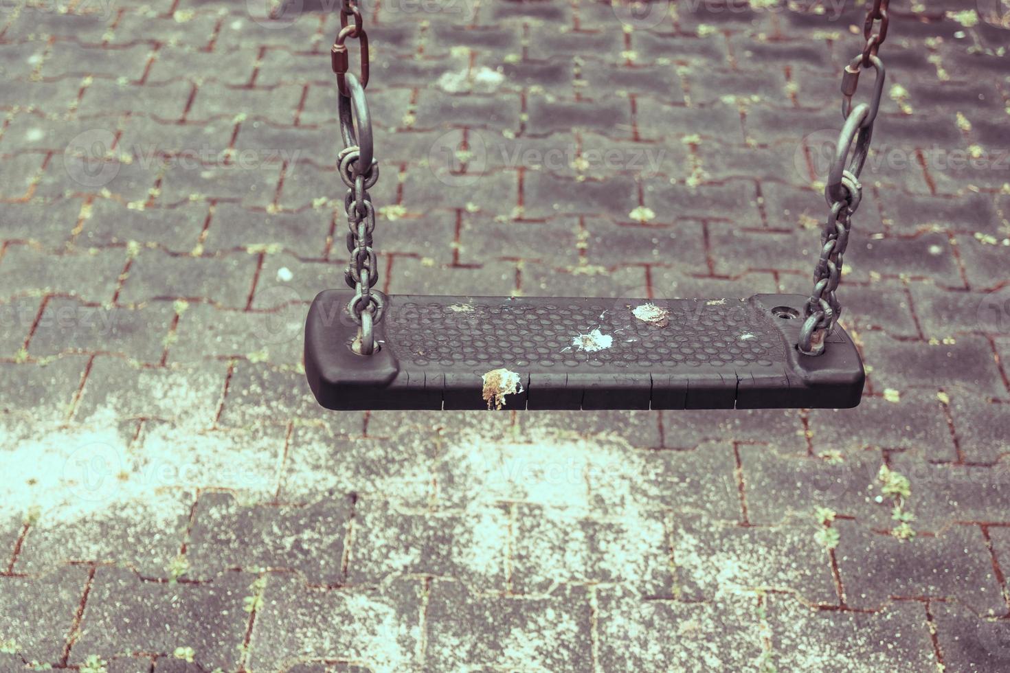 an empty swing on a playground photo