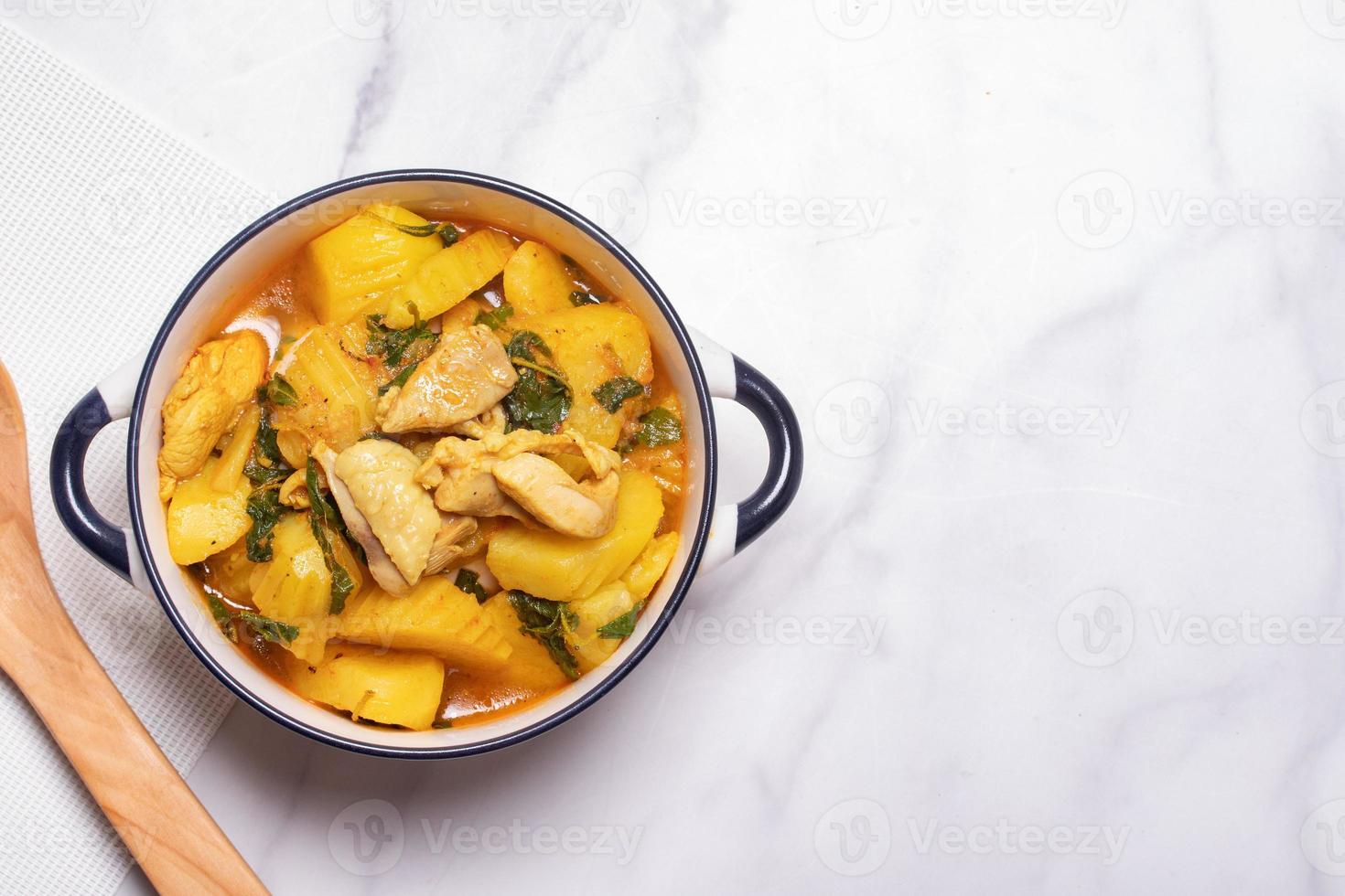 Chicken and Potato Curry with Basil Leaves in a Thai White Bowl photo