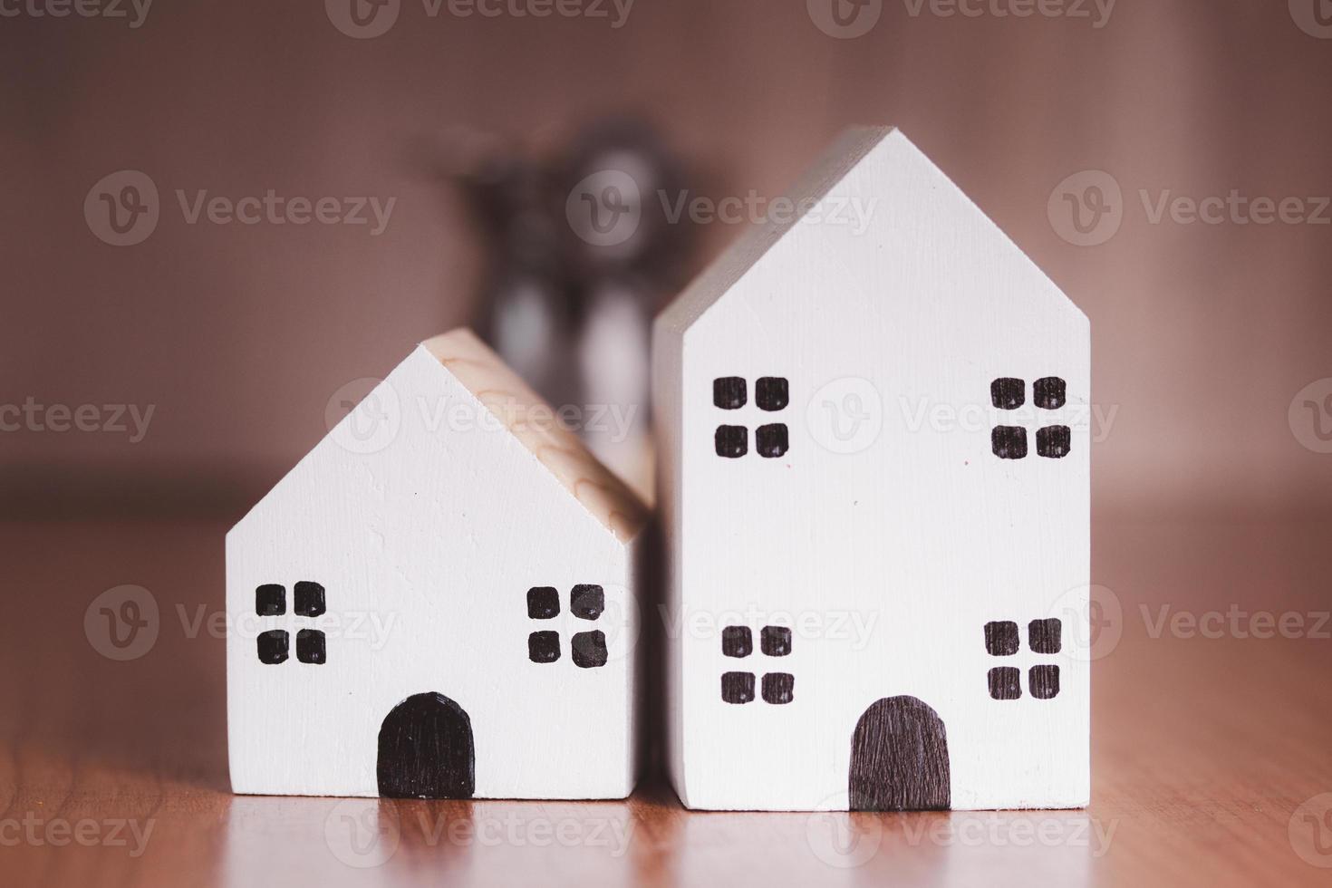 Two small white wooden houses on the table photo
