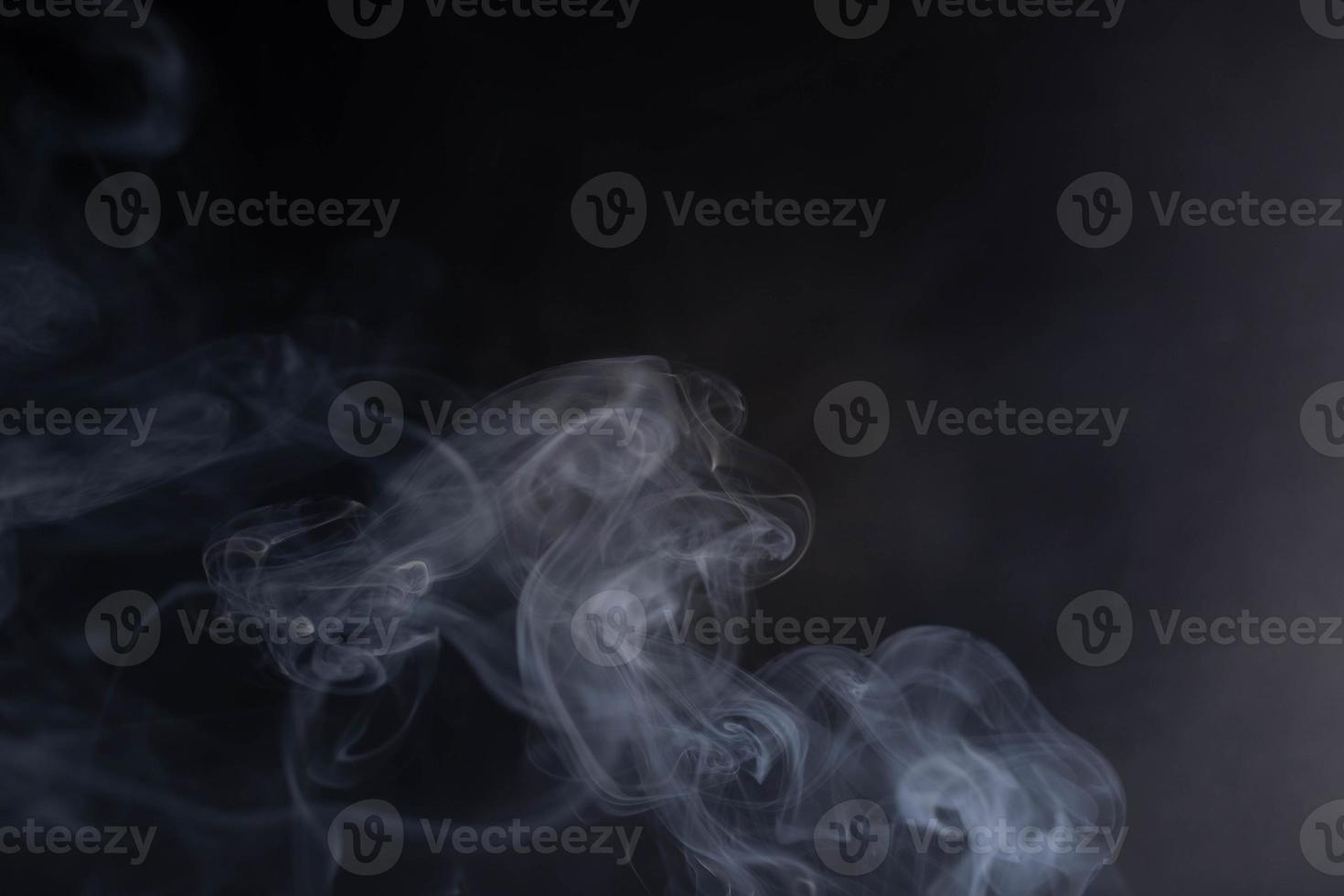 frankincense with white smoke on black background photo
