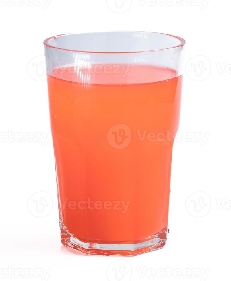 Orange juice drink mixed with mixed fruit in a clear glass photo