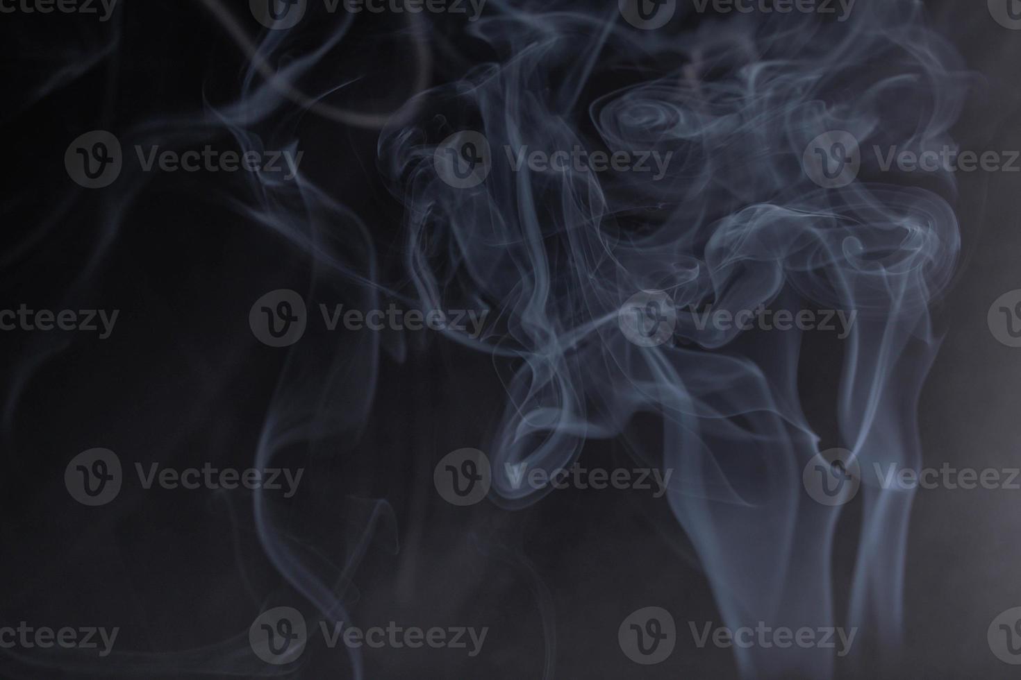 frankincense with white smoke on black background photo