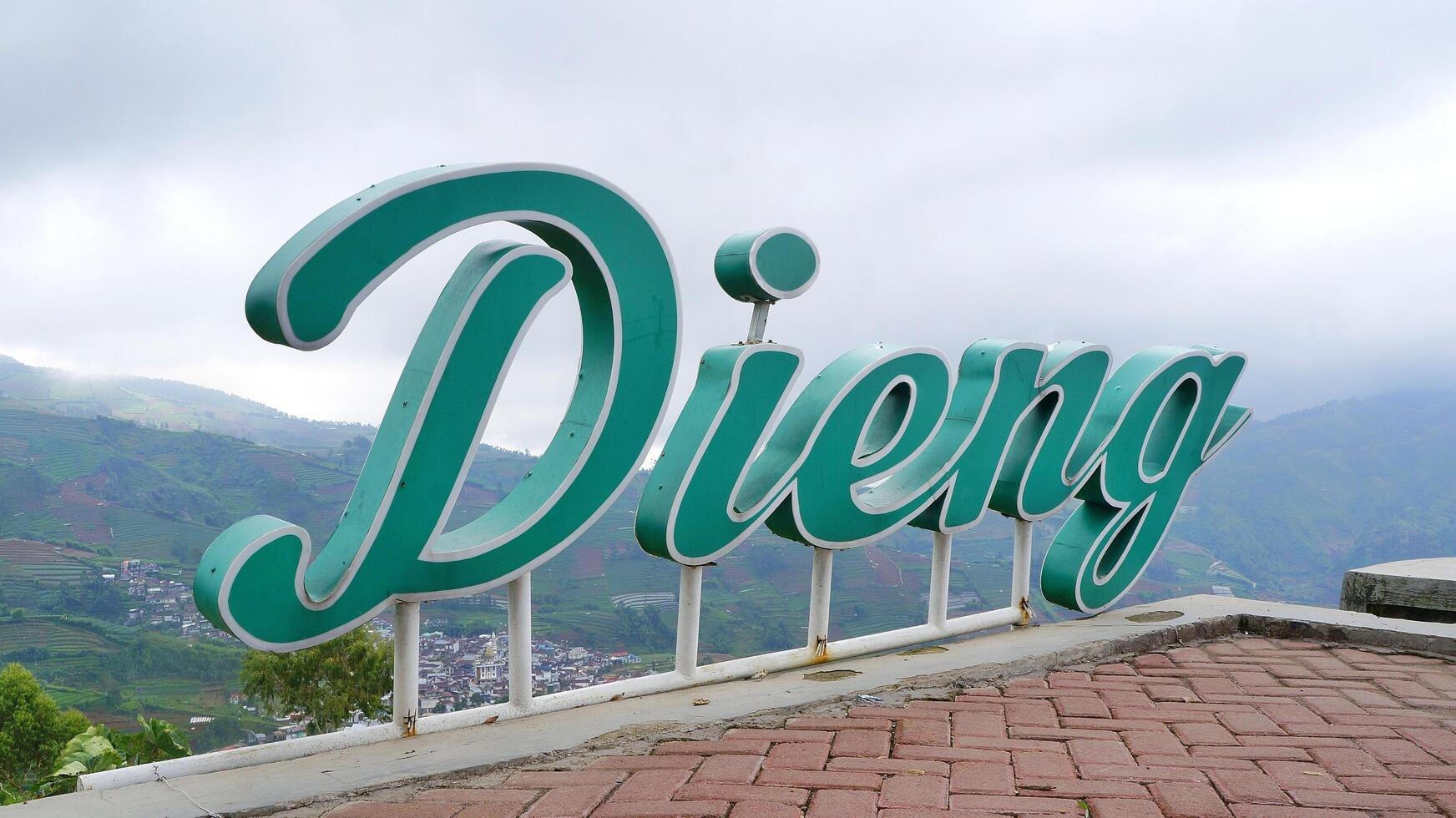 the iconic DIENG writing on a hill with a natural view photo