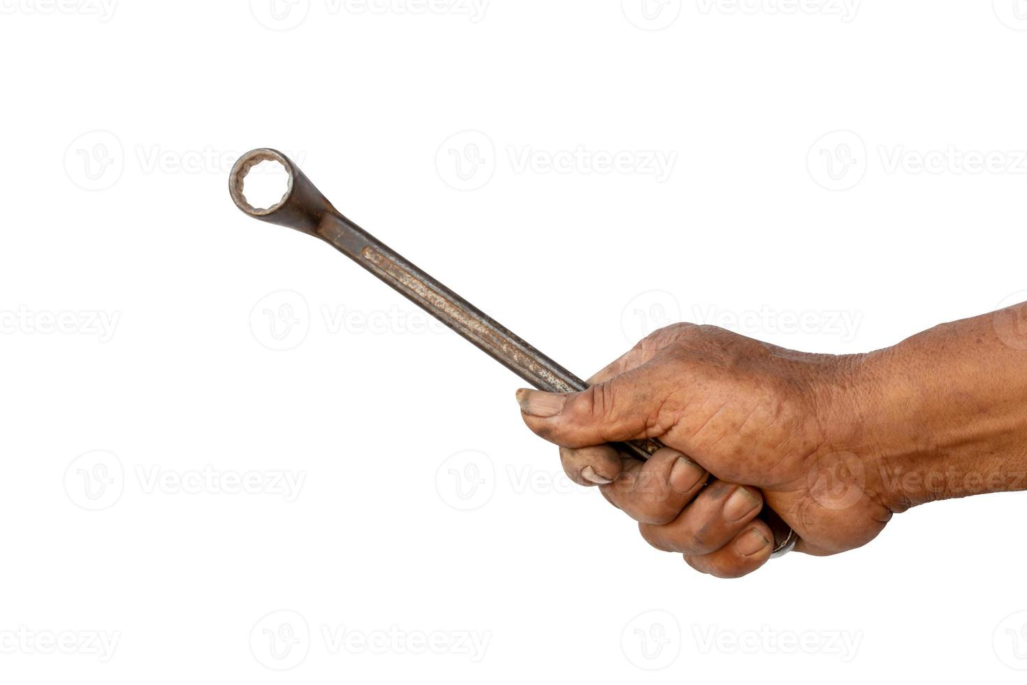 The hand of the mechanic is holding a wrench photo