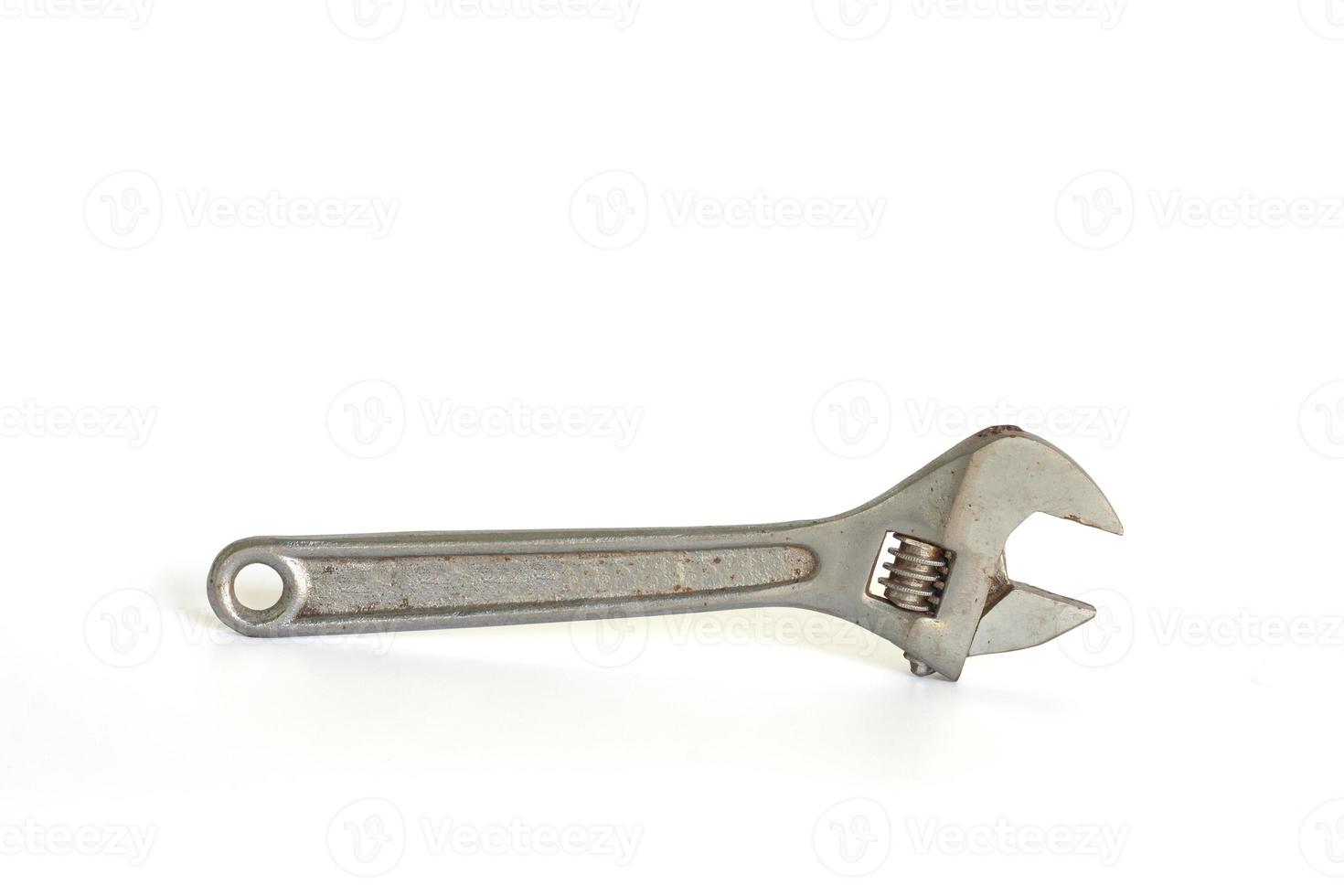 Old rusted adjustable spanner isolated on white background included clipping path. photo