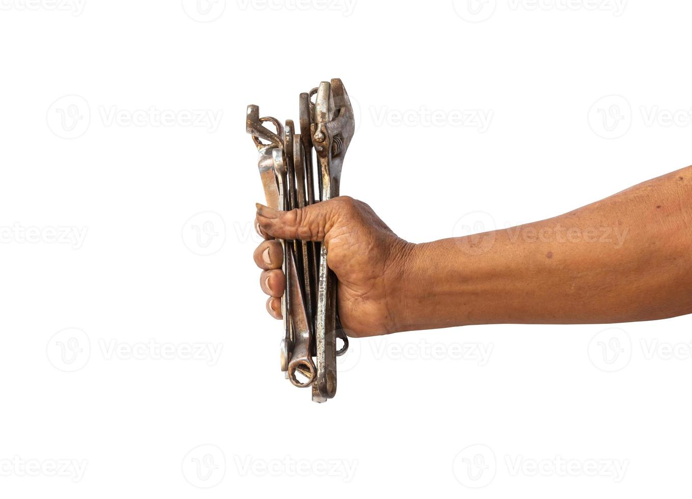 A man holds old and rusty tools for mechanic work photo