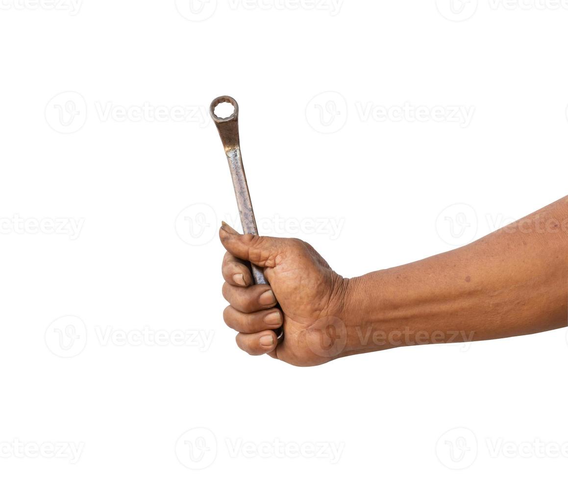 The hand of the mechanic is holding an old wrench isolated photo