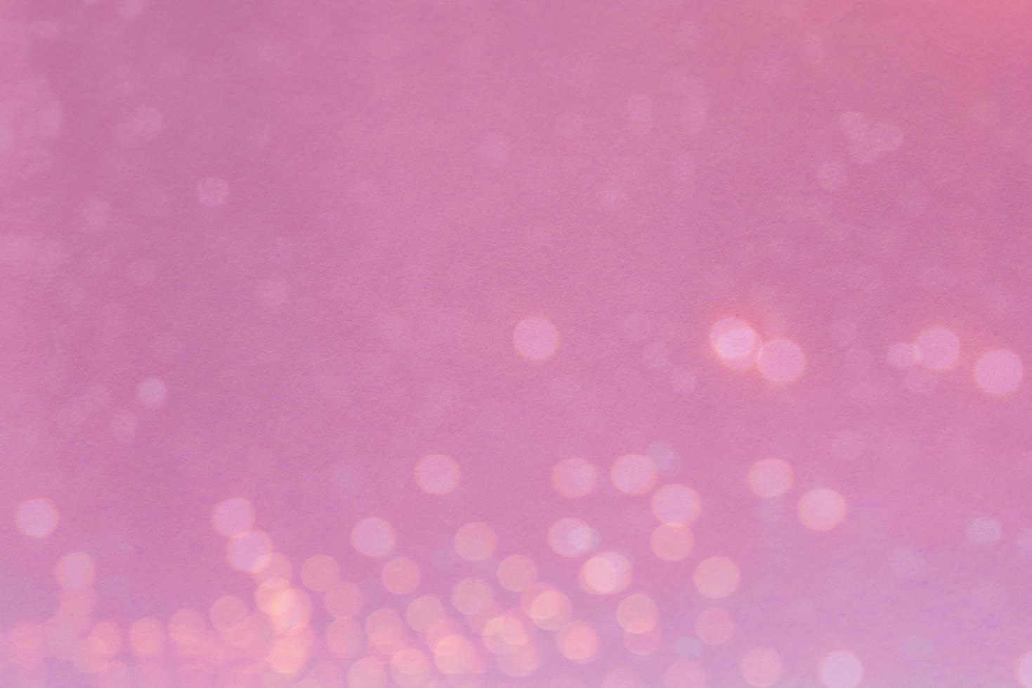 Abstract blurred light bokeh on pink background photo