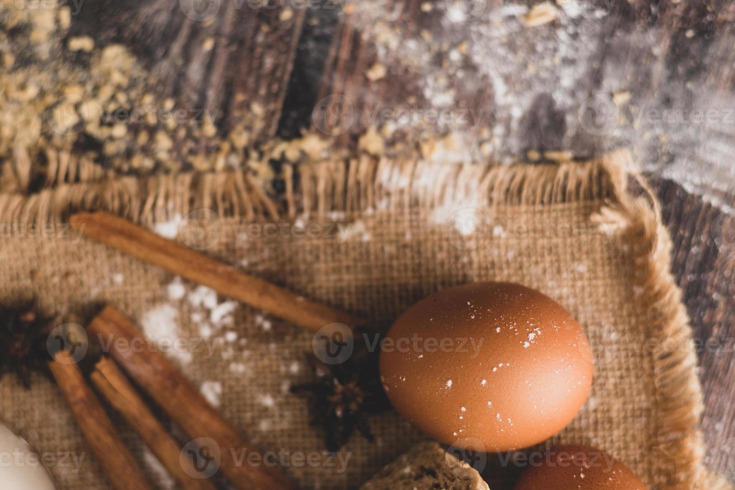 Cinnamon and eggs are placed on the sack and the flour photo
