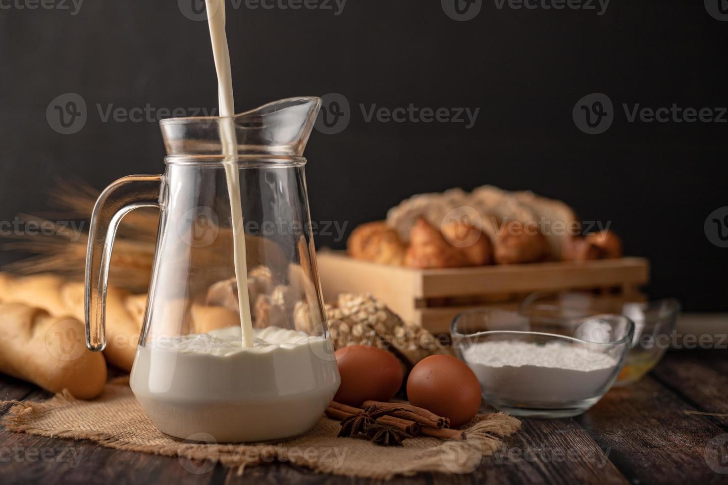 Pour the milk in a jug placed on the sack photo