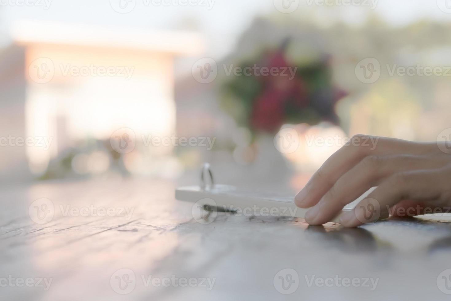hand holding key chain on the wooden table photo