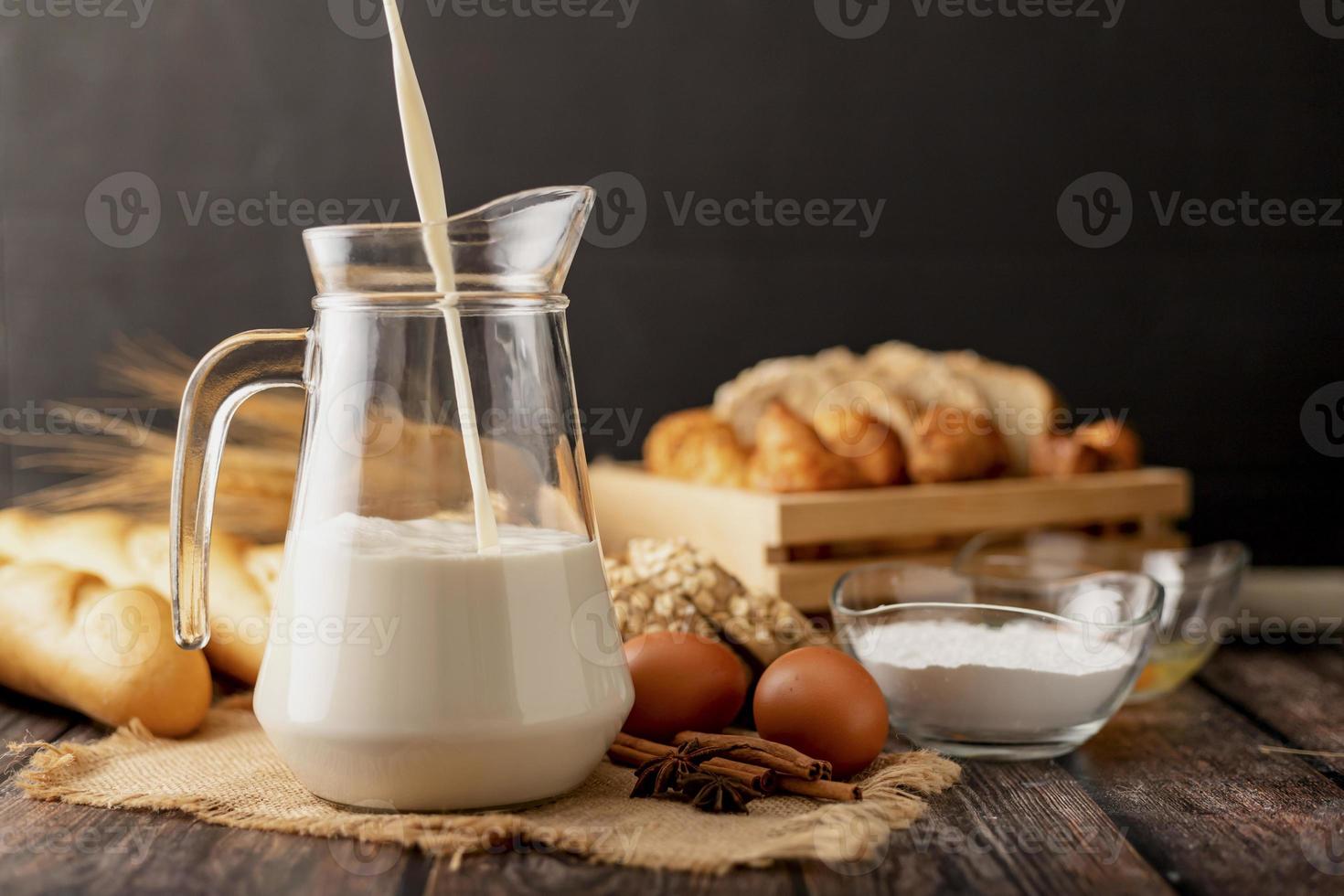 Pour the milk in a jug placed on the sack photo