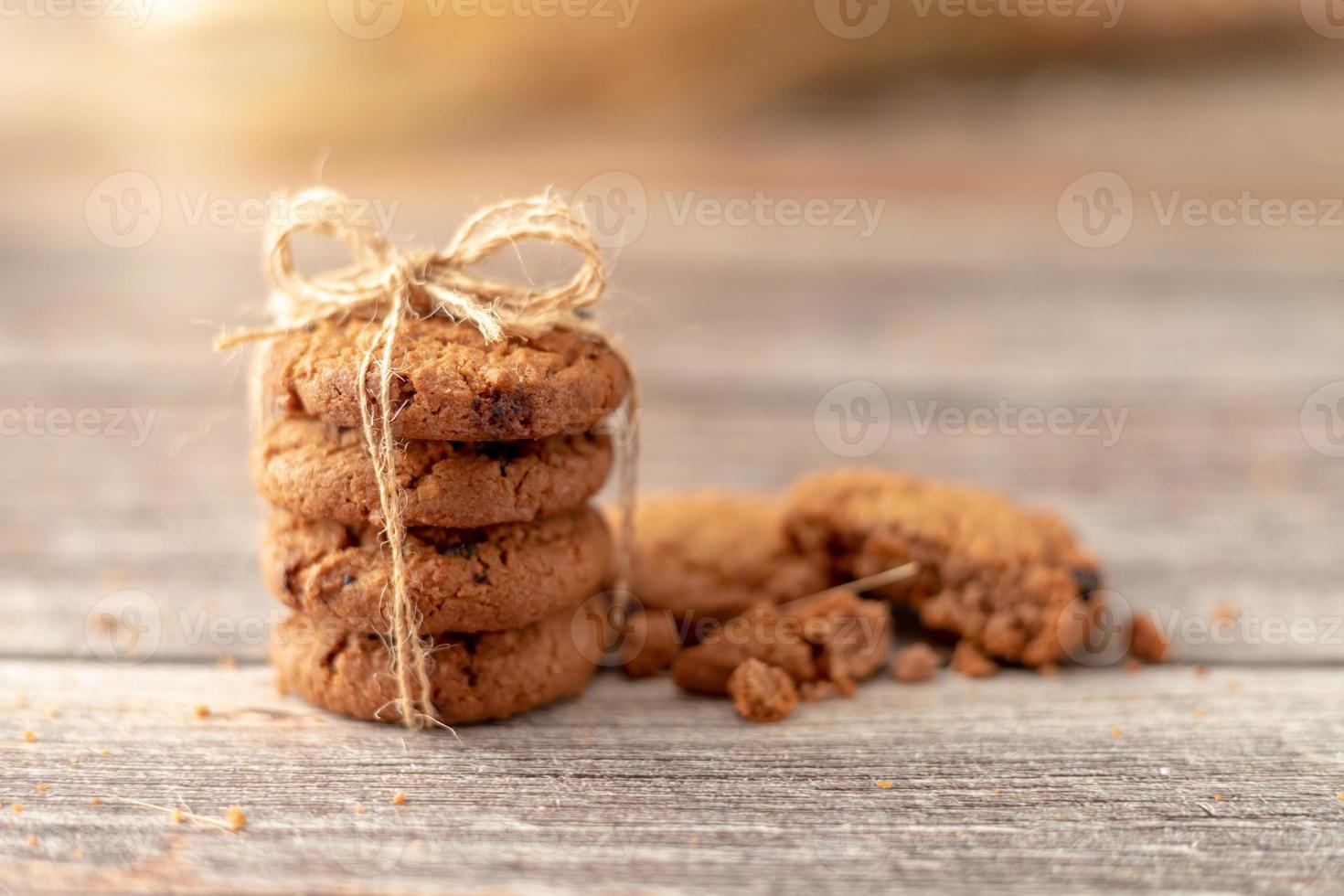 Stacked cookies use a rope tied on a wooden table photo