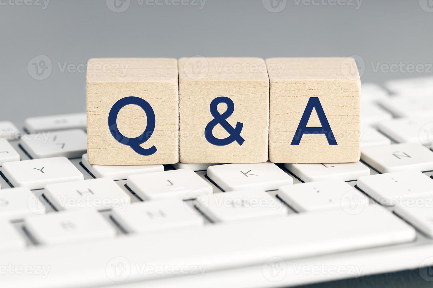 Q and A word on wooden block on computer keyboard. Questions and