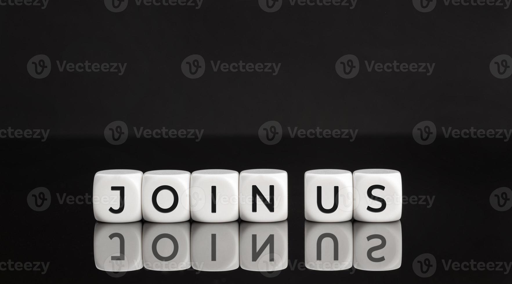 Join us phrase on white blocks on black background. Copy space photo