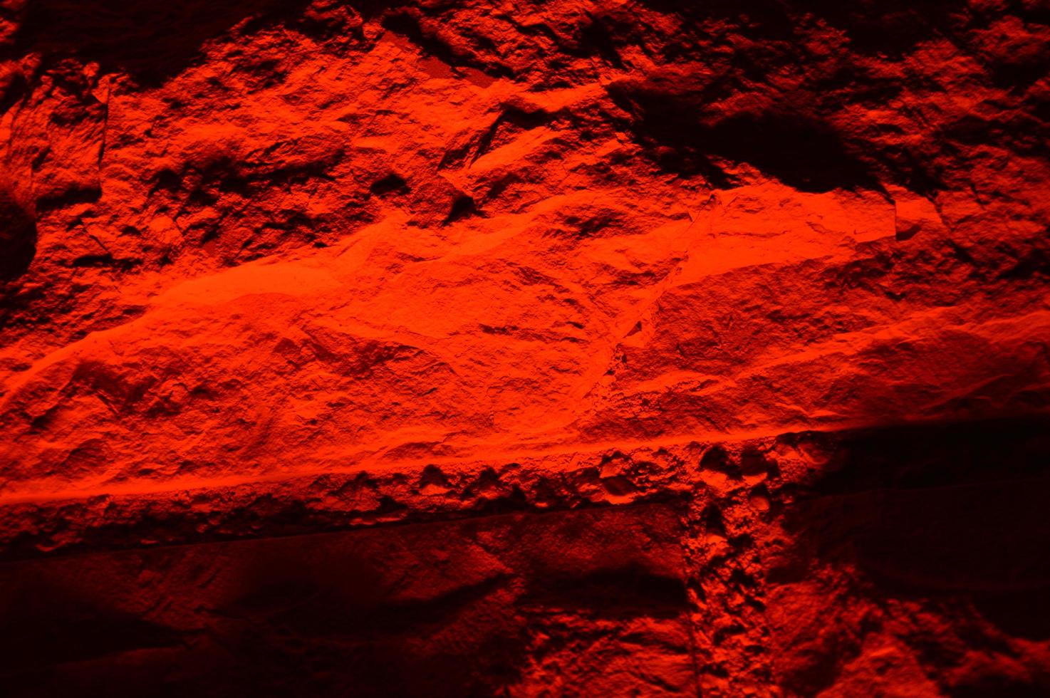 A red illuminated brick wall photo
