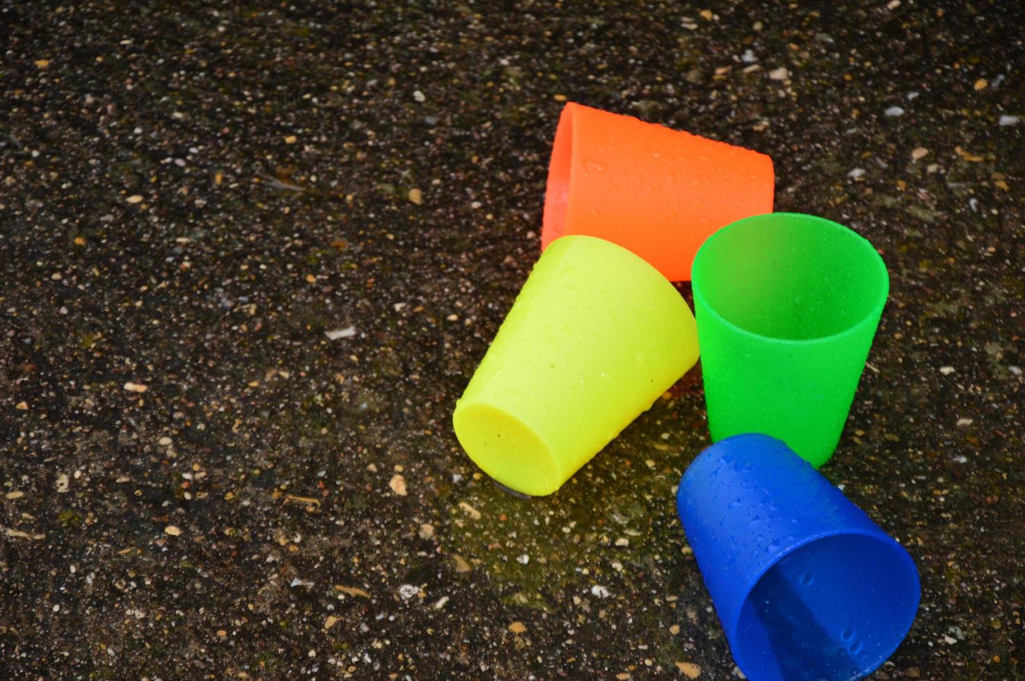 Colorful plastic cups in the rain photo