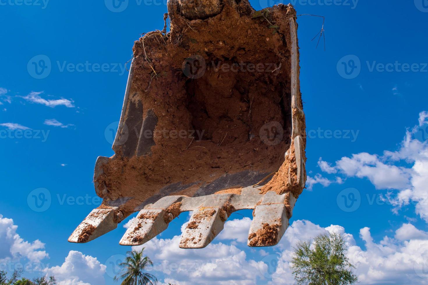Clay at the bucket of tracked excavator photo