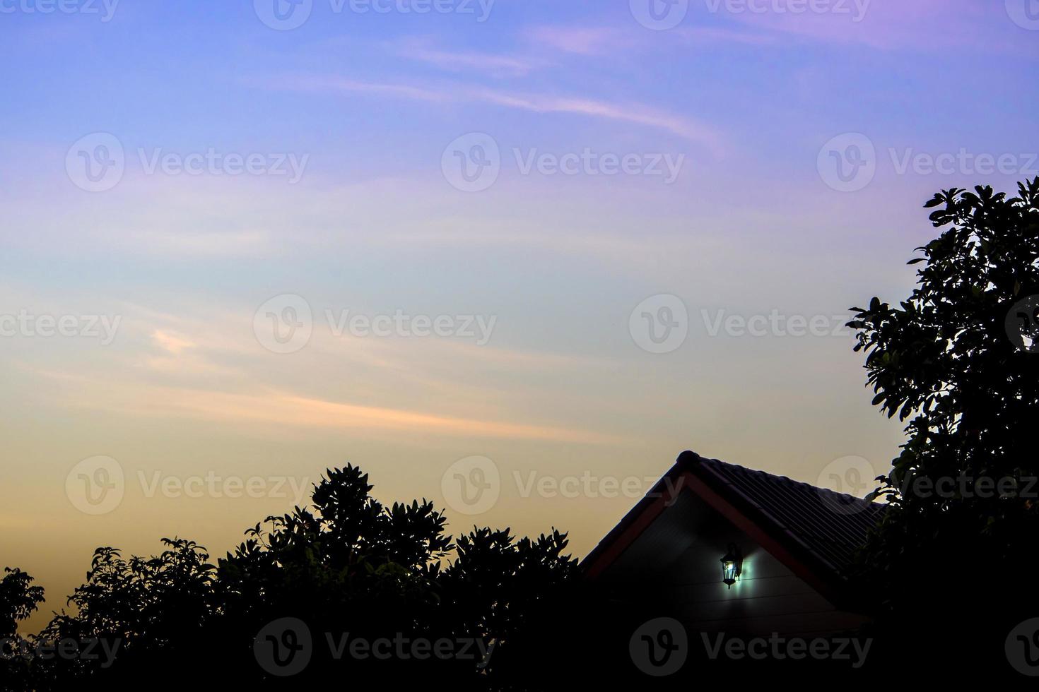 Silhouette of house and tree in the morning photo