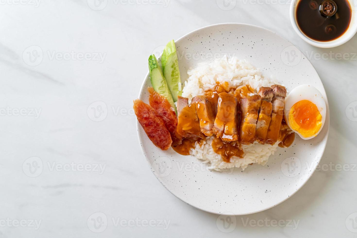 crispy pork on rice with barbecue sauce photo