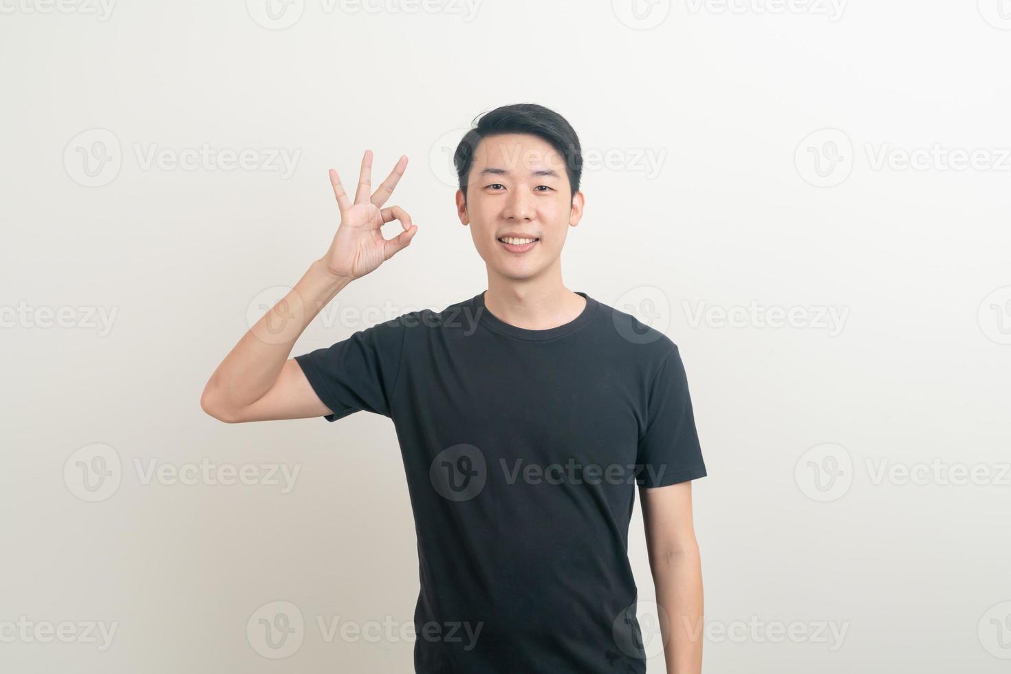 young Asian man thumbs up or ok hand sign photo