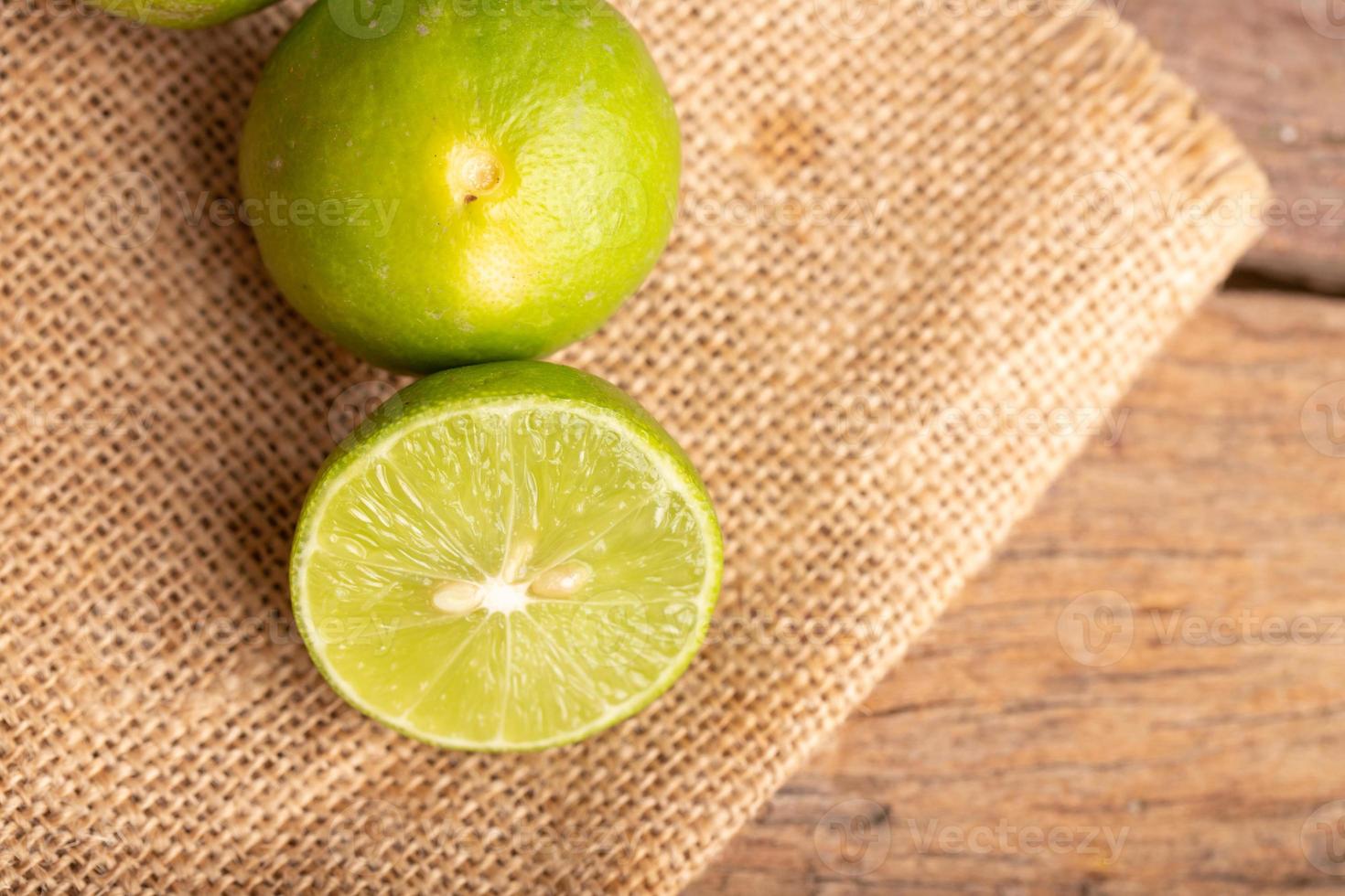 Close up a half of the green lime and seed place on the woven sack photo