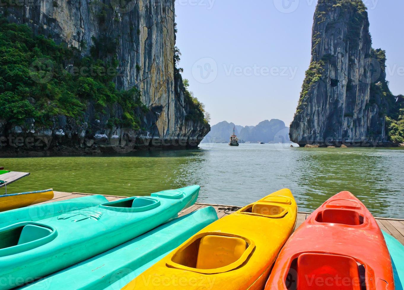 Colourful kayaks with limestone mountains background at Halong bay, Vietnam photo