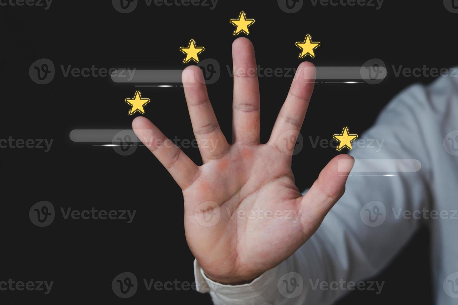 Customer review concept. Around the hands, there are five stars. There are boxes for text. Close up shot isolated on black background. photo