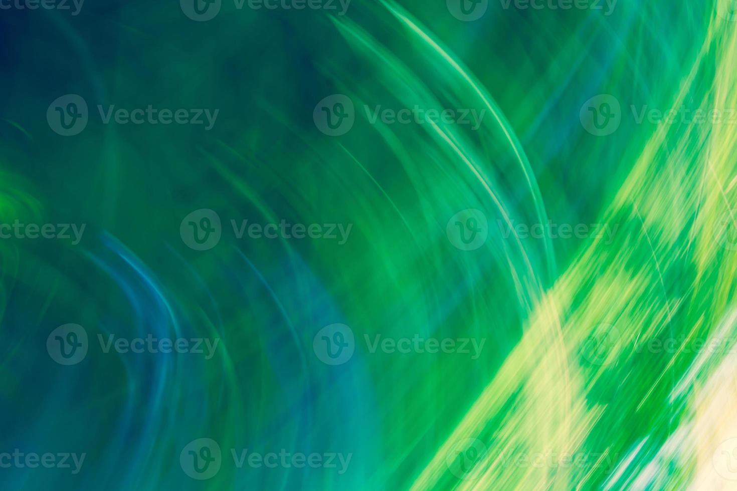 Bright abstract background in shades of green with a gradient and glowing stripes photo