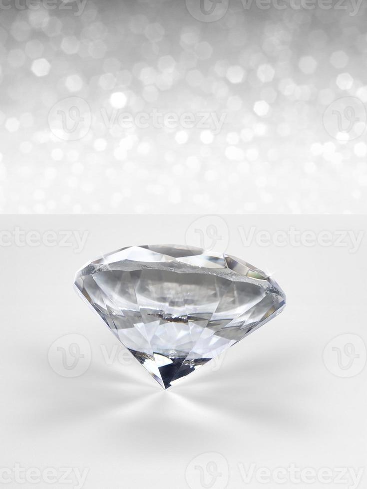 Diamonds of placed on white shining bokeh background. concept for selection best diamond gem design photo