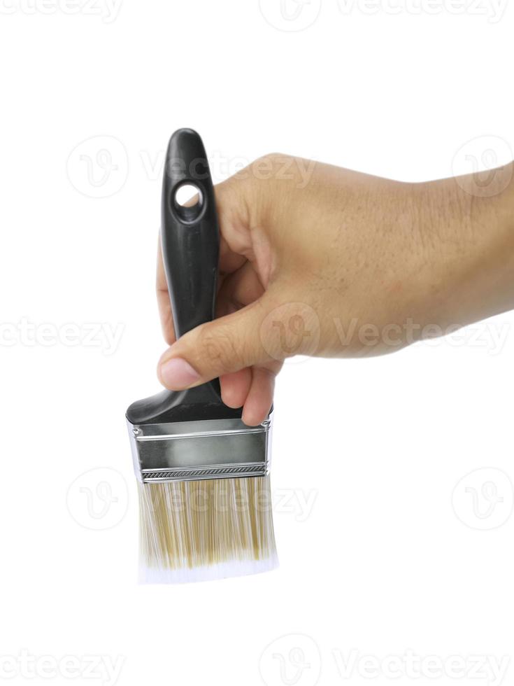 hand holding Paintbrush isolated on white background photo