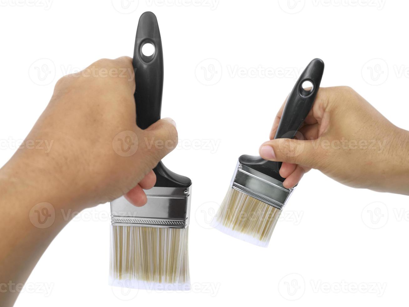 hand holding Paintbrush isolated on white background photo