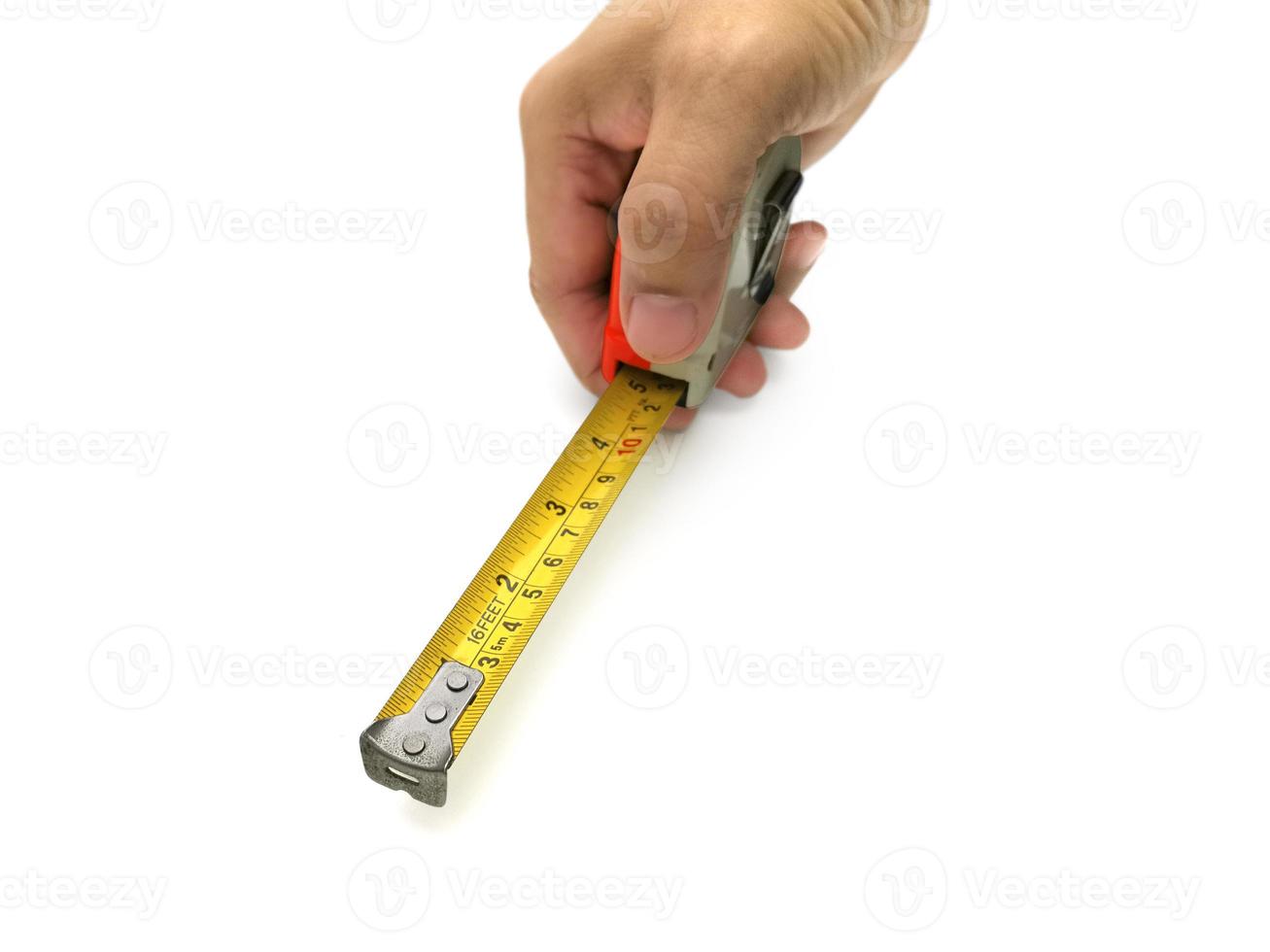 Construction roulette in hands on white background photo