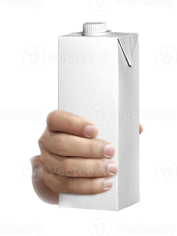 carton of milk or juice package in hand isolated on white background photo