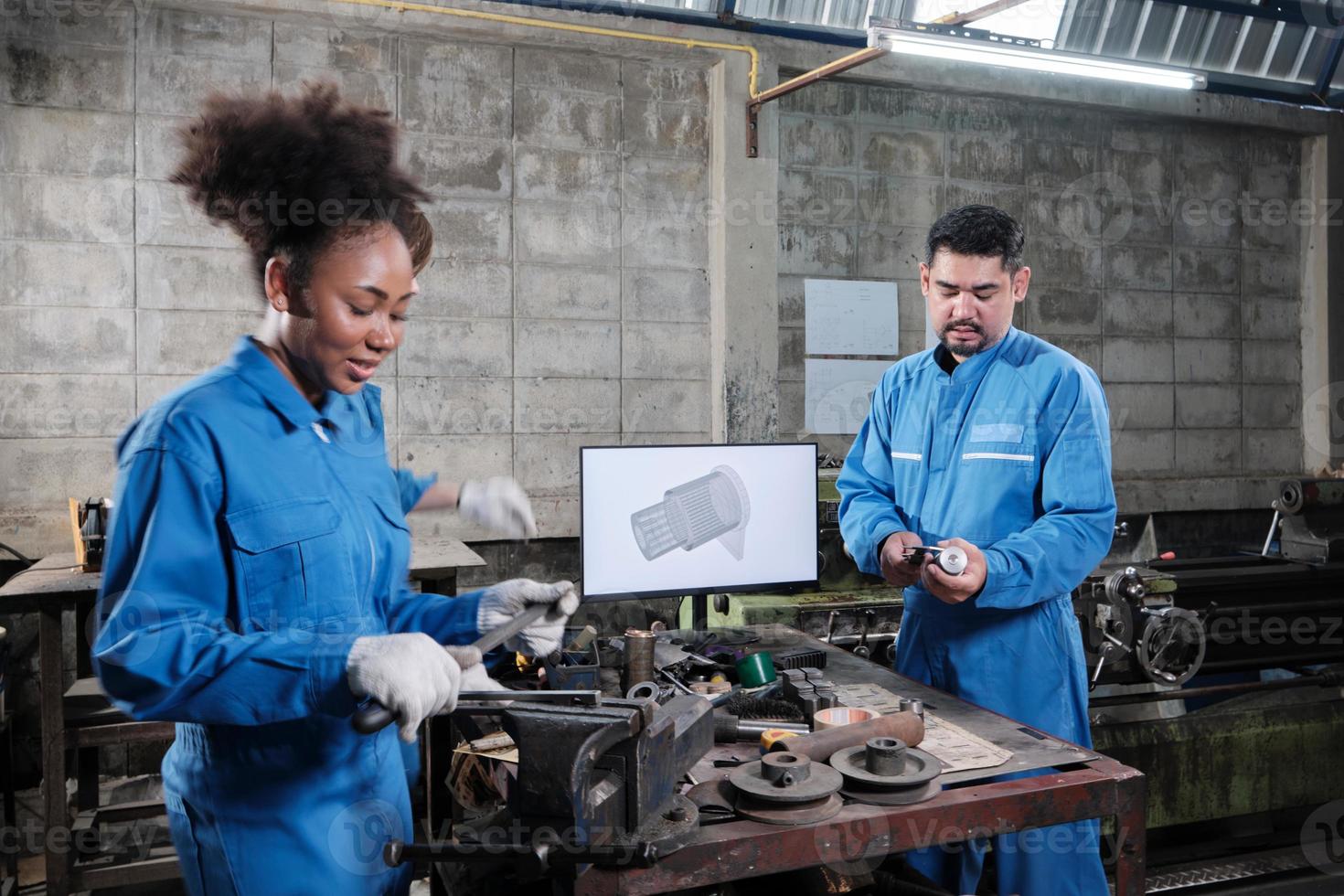 Three multiracial professional industry engineer workers teams in safety uniforms metalwork jobs discuss with mechanical drawing in a monitor, lathe machines, and workshop in manufacturing factory. photo