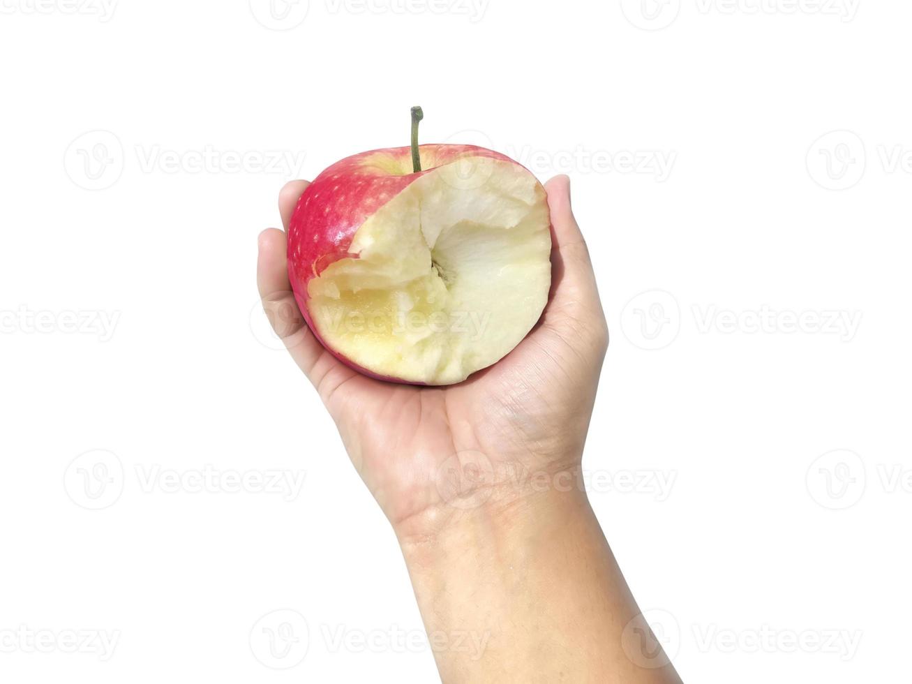 Red apple with missing a bite in hand isolated on white background photo