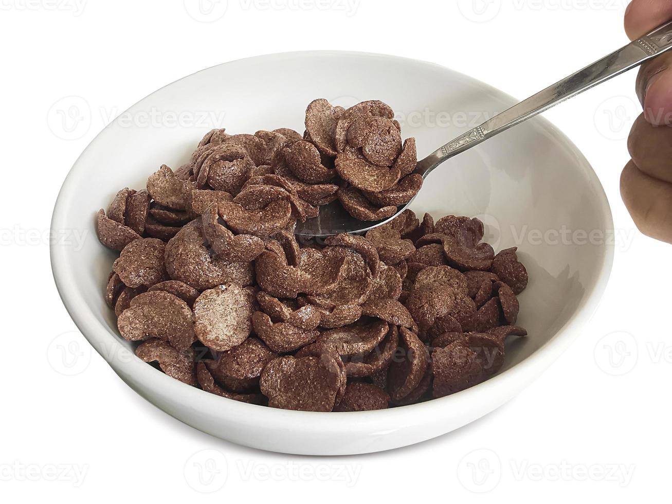 dry breakfast in a plate on a white background. Chocolate cereals photo