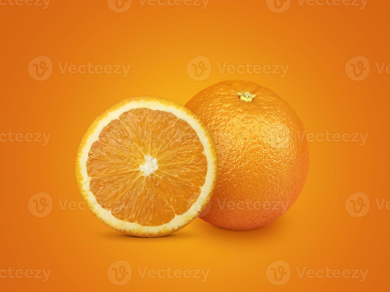 Orange fruit with orange slices isolated on orange background photo