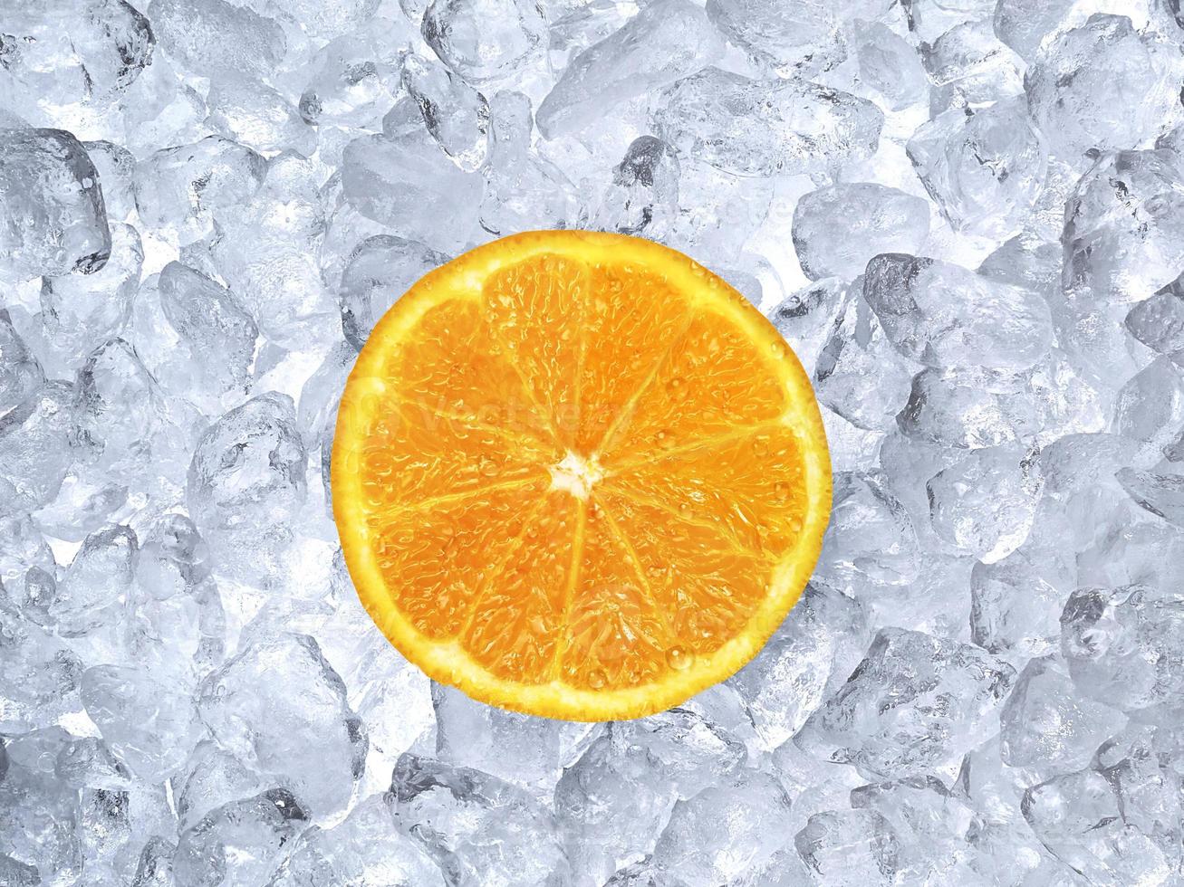 Fresh orange on ice cubes background photo
