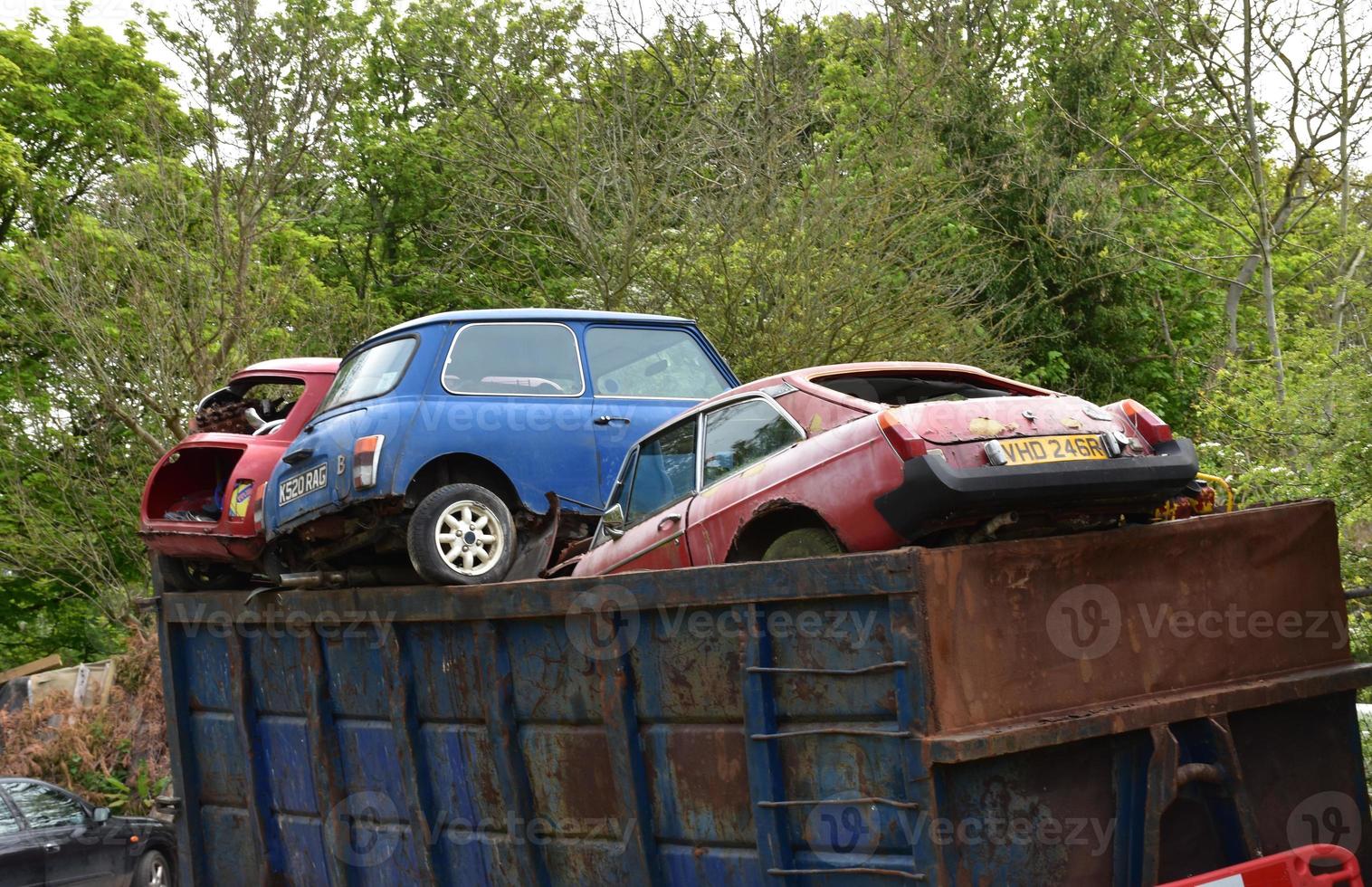 Dumpster Filled with Used Cars Thrown Away photo